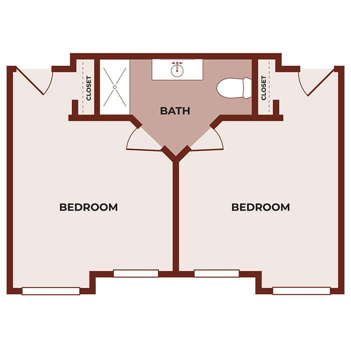 Floor plan with two bedrooms on either side of a central bathroom. Each bedroom has a closet near the shared bathroom, and both rooms have doors opening toward the center hallway leading to the bathroom.